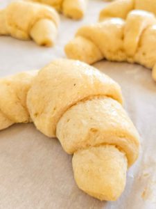 soft and fluffy gluten free crescent roll on a baking sheet