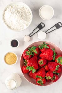 ingredients for gluten free strawberry shortcake: strawerries, sugar, floour, salt, baking powder, vanilla, and cream