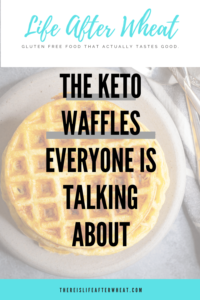 a stack of circular waffles sits on a gray stone plate next to a white and tray striped linen and a stack of tarnished silver forks. A text overlay reads "the keto waffles everyone is talking about