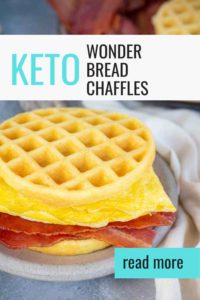Eggs and strips of bacon sandwiched between two keto wonder bread chaffles