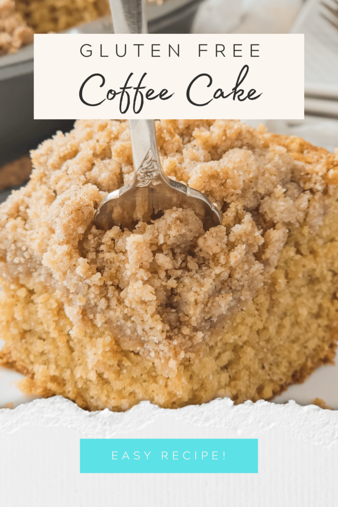 A fork is slicing into a piece of coffee cake with lots of crumb topping.