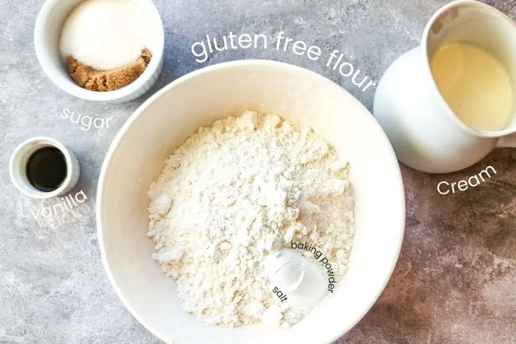 Ingredients in gluten free peach cobbler: gluten free flour, baking powder, salt, brown and white sugar, cream, and vanilla