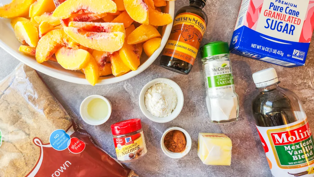 Ingredients in gluten free peach cobbler, fruit mixture: Frozen peaches, brown sugar, white sugar, vanilla, almond extract, lemon juice, cornstarch, butter, cinnamon, and nutmeg