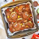 A pan of brownies topped with Reese's cups and googly eyes