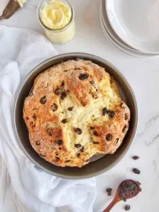 a round loaf of Irish soda bread in a cake pan.