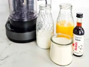 ingredients in orange julius protein ice cream: milk, orange juice, protein powder, and vanilla