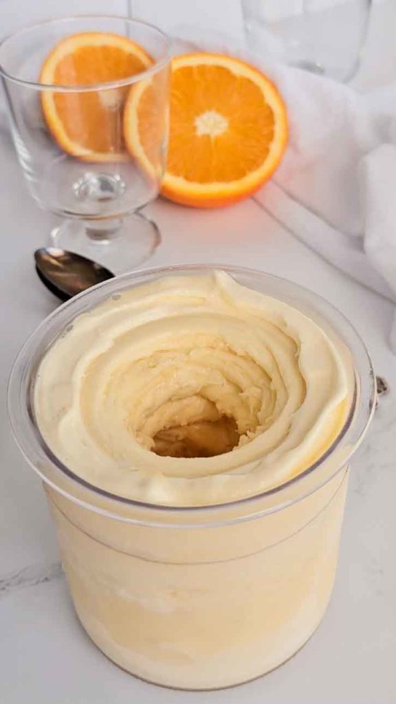 orange julius protein ice cream in container with swirls on top
