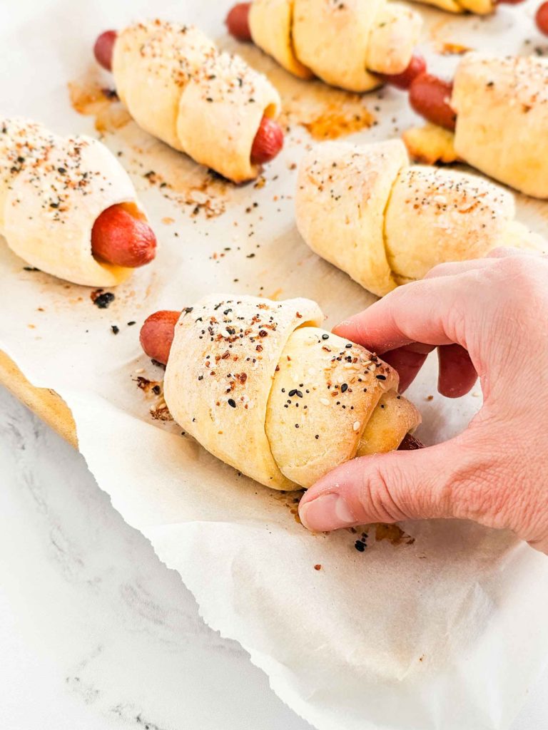 hot dogs wrapped in bread dough and sprinkled with everything bagel seasoning