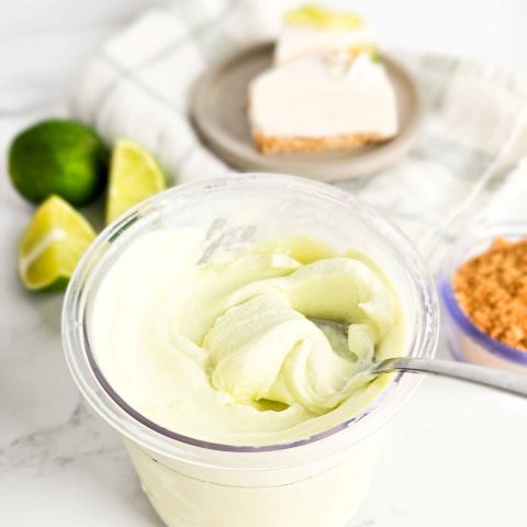 a spoon in a container of creamy ice cream