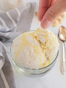 sprinkling flaky salt on top of cashew ice cream