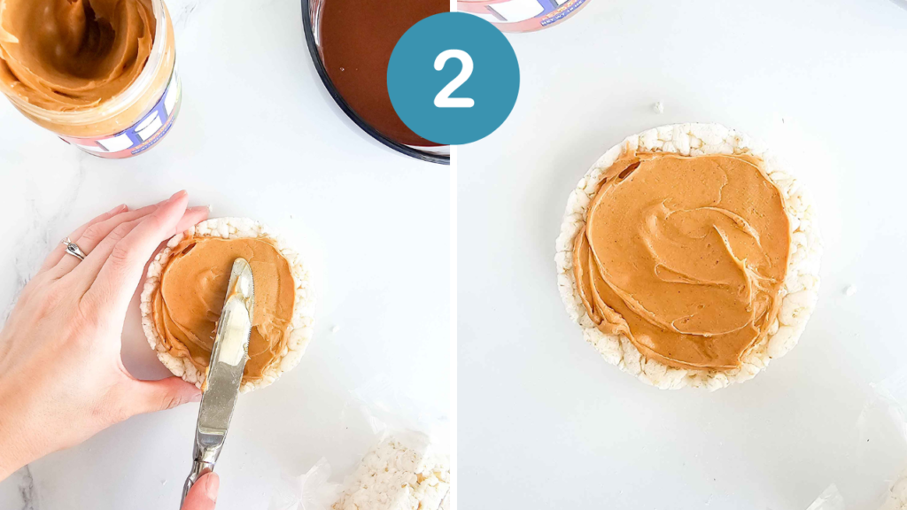 a hand spreads peanut butter onto a rice cake