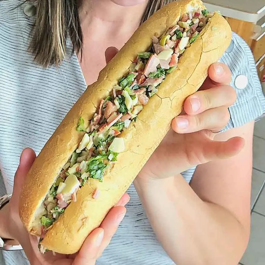 a woman holding a sandwich