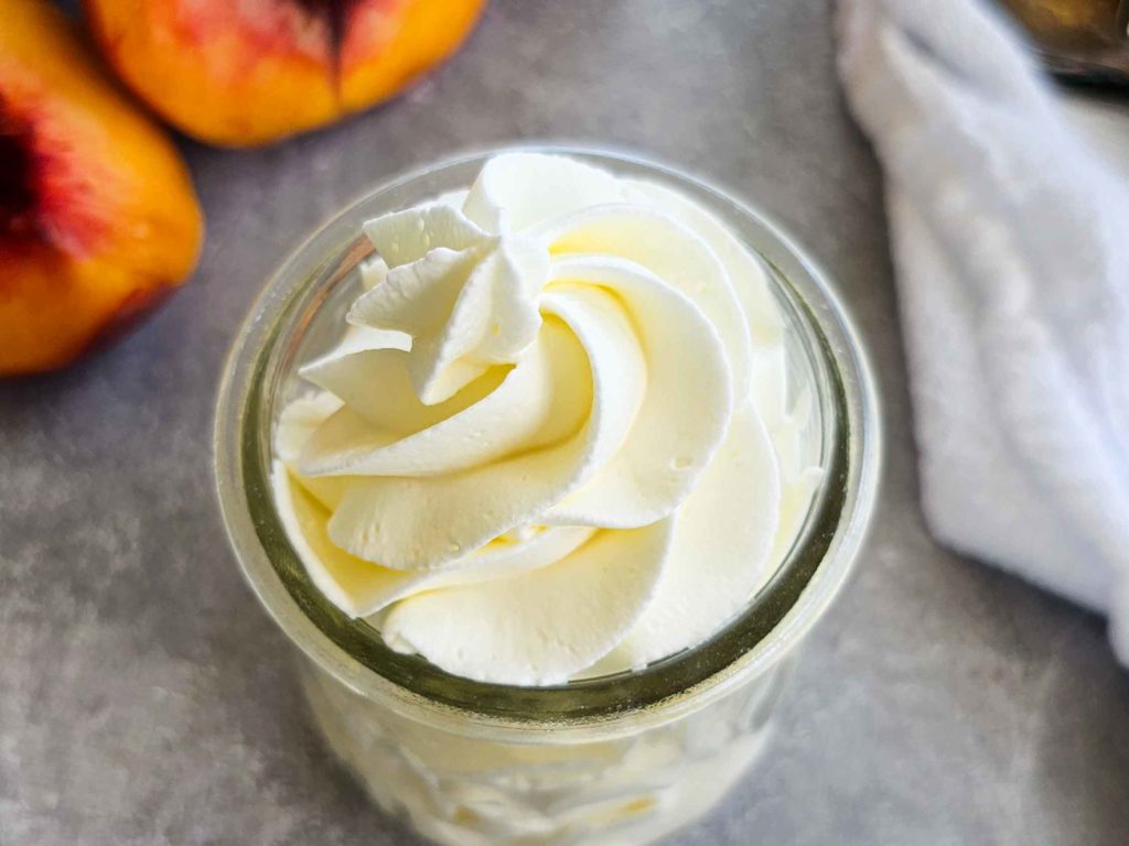 a glass jar with whipped cream