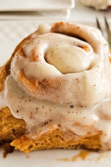 tall and fluffy glazed cinnamon roll